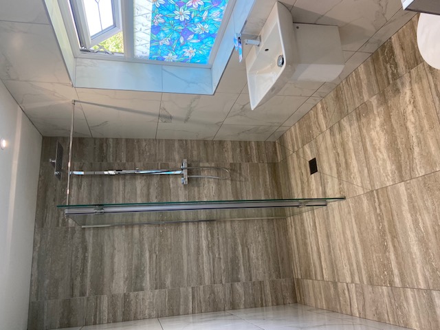 Grey stone-effect bathroom with concealed shower valve