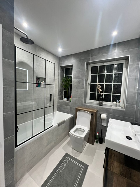 Grey bathroom with vanity unit and black heated towel rail