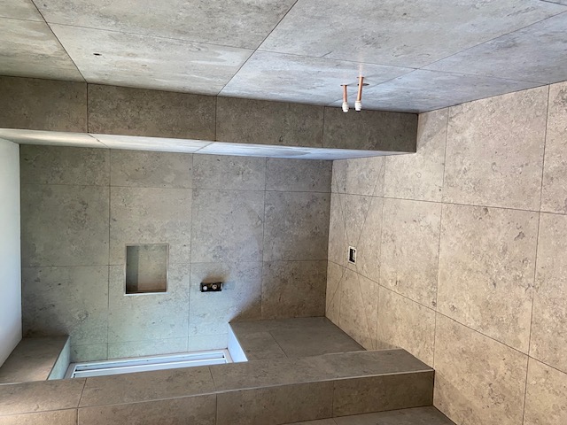 Travertine walk-in shower with rainfall head